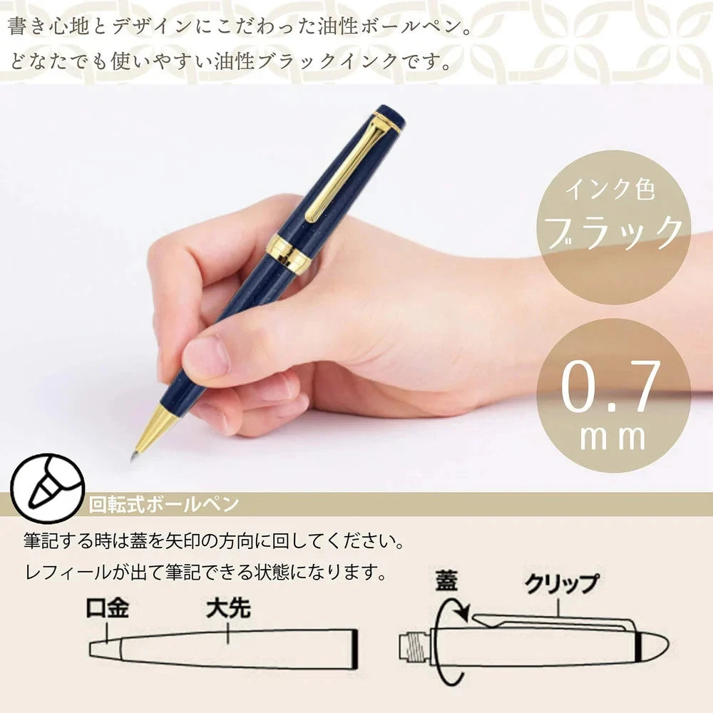 Pen being held in a hand with close-up details on ink cartridge and pen body, on a light background.