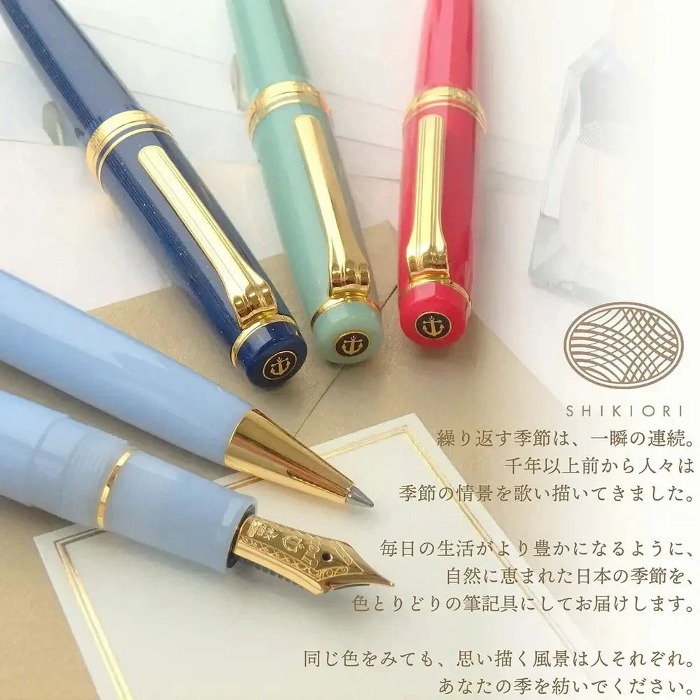 Set of fountain pens with gold accents on a white background, featuring the Shikiori brand.